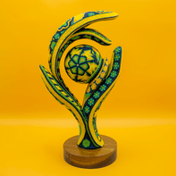 Conceptual resin trophy on a wooden base.