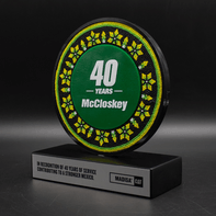 Acrylic circle with a customized center on a wooden base.