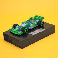 Resin race cars on a wooden base.