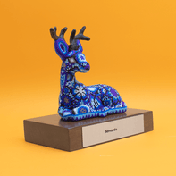 Ceramic deer with custom colors on a wooden base.