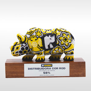 Escultura de rinoceronte montado sobrea base de madera con placa de metal