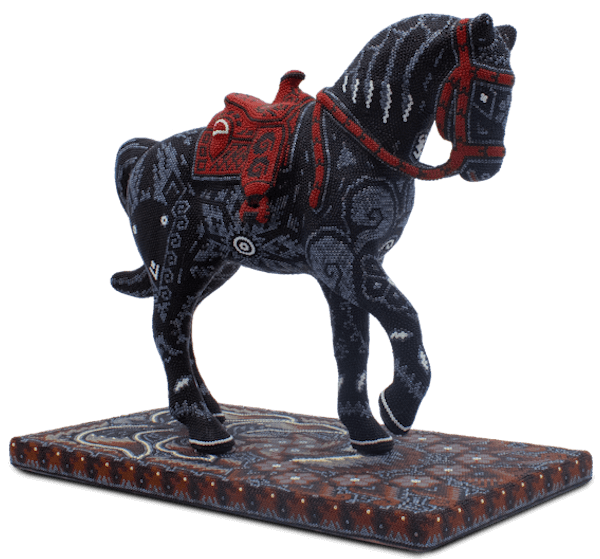 Sculpture of a horse covered with black and red beads