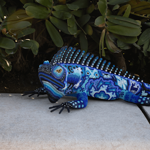 Iguana sculpture covered with blue and white beads