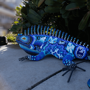 Iguana sculpture covered with blue and white beads